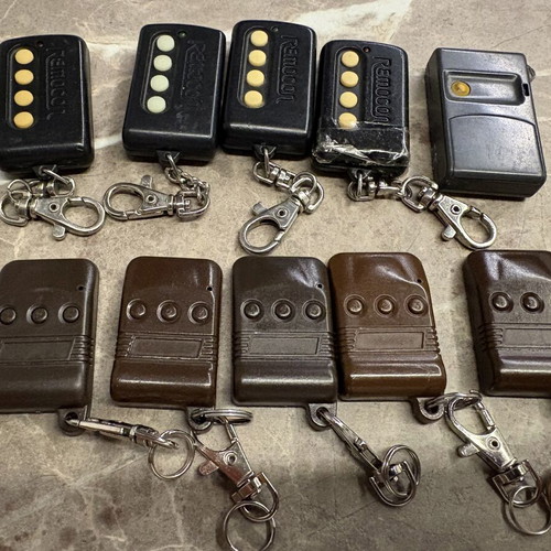 Garage door remotes used, set of 10, one broken with tape
