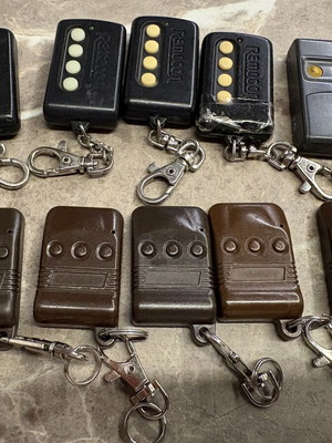 Garage door remotes used, set of 10, one broken with tape