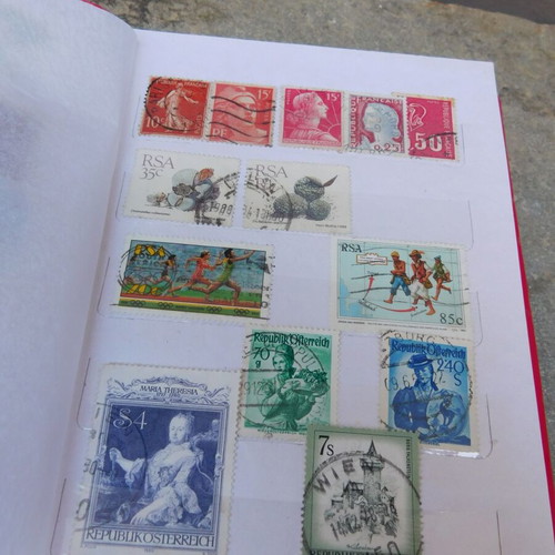 Red album with worldwide collectible stamps