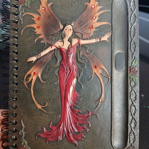 Iron notebook like new with embossed designs and magnet
