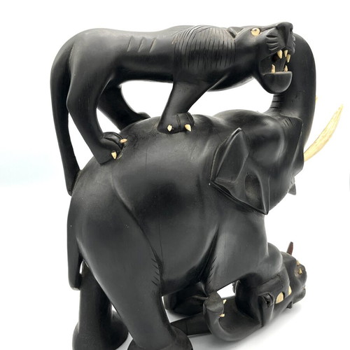 Vintage handmade ebony wood sculpture of elephant and lions
