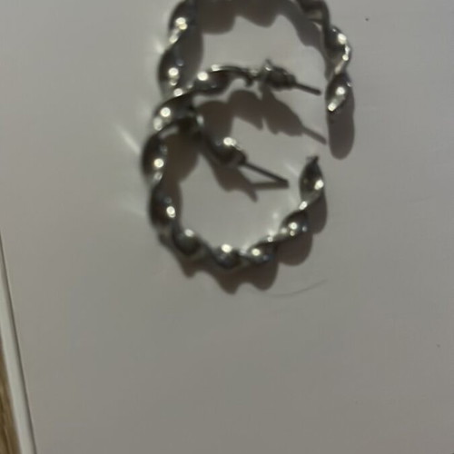 Silver hoop earrings with embossed design, pair