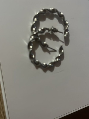 Silver hoop earrings with embossed design, pair