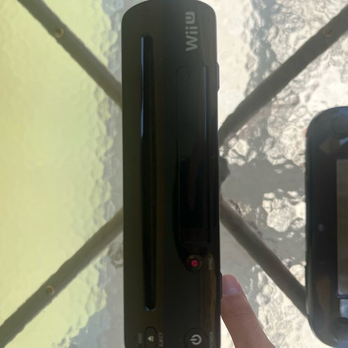 Nintendo Wii U console used with game cartridges and cables