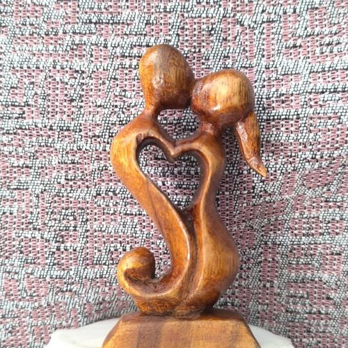 Wooden sculpture embrace like new, natural material decoration