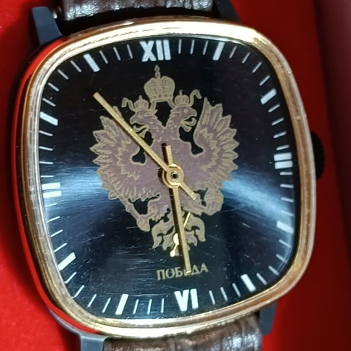 Pobeda vintage Soviet Russian mechanical watch with square case and double-headed eagle emblem