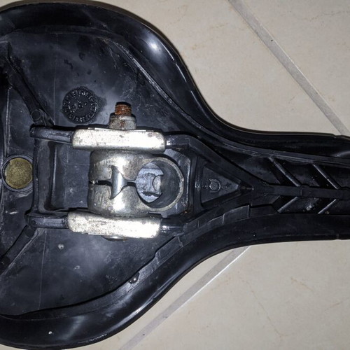 Comfortable black bicycle saddle with mounting clamp