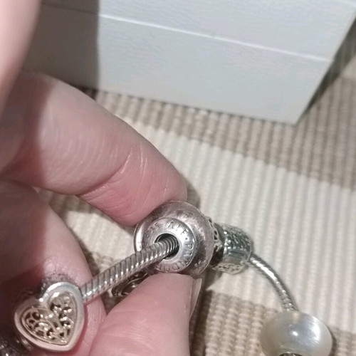 Pandora silver bracelet with 11 charms and collectible clasp, like new
