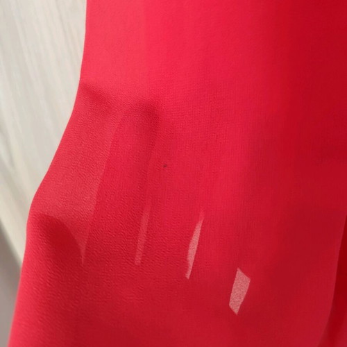 Coral dress with a jewel tie at the neck