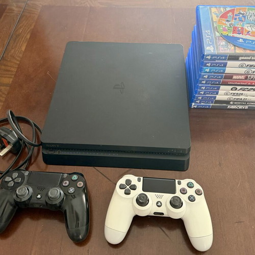 PlayStation 4 Slim 500GB used with 2 controllers and 11 games