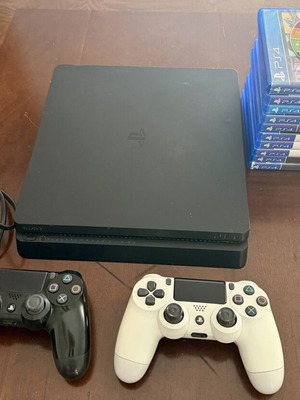 PlayStation 4 Slim 500GB used with 2 controllers and 11 games