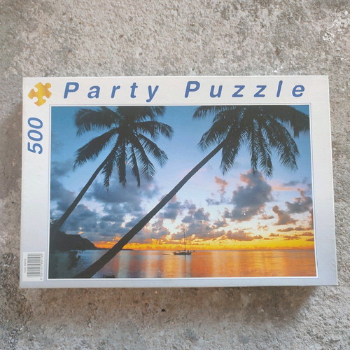 Party Puzzle 500 pieces used with sunset and palm trees
