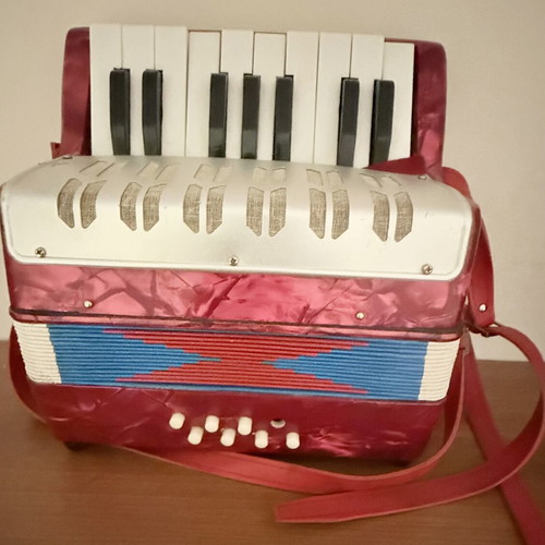 Children's accordion used, red with blue and red bellows