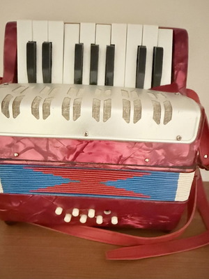 Children's accordion used, red with blue and red bellows