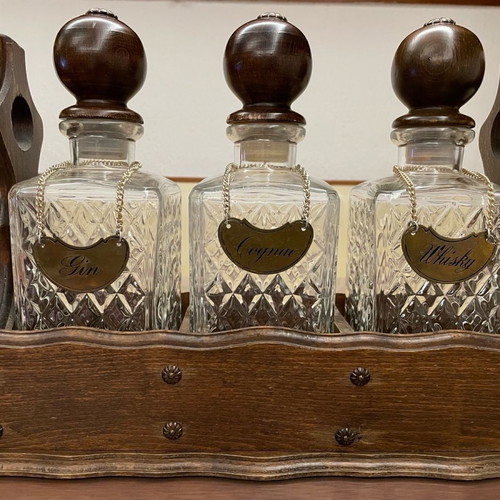 Vintage English decanters used in wooden stand for gin, cognac, whisky