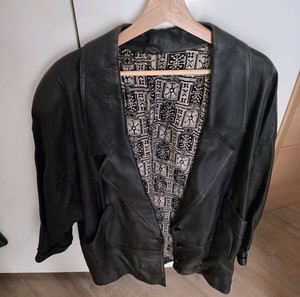 vintage black soft leather jacket with buttons and shoulder pads in great condition