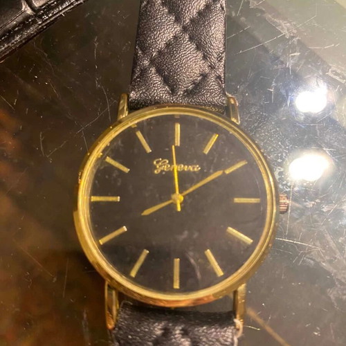 Geneva watch used with black quilted leatherette strap and gold case