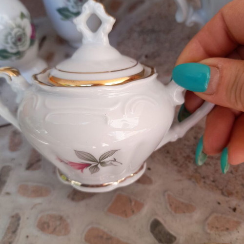 Porcelain tea set collectible with gold details and small vases like new