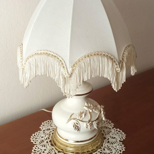 Vintage porcelain table lamp with fabric white shade and fringes used