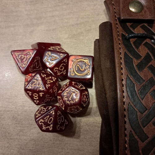 Runic leather dice bag with red D&D dragon dice set