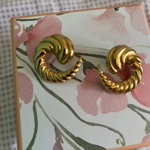 Gold earrings in snake, crescent, and spiral shapes like new