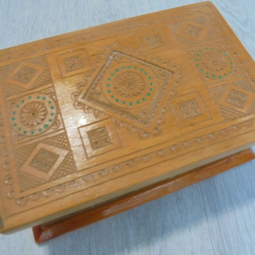 Old wooden carved box with decorative ornaments, used