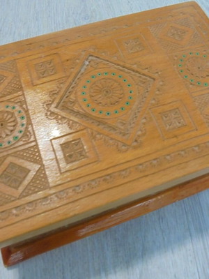 Old wooden carved box with decorative ornaments, used