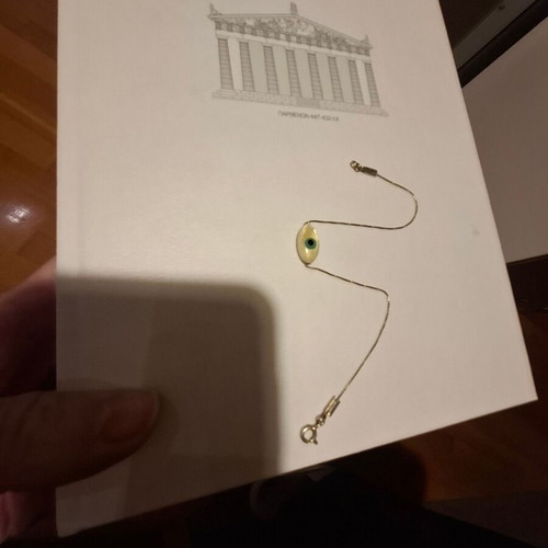 Thin bracelet with metal chain and eye centerpiece like new