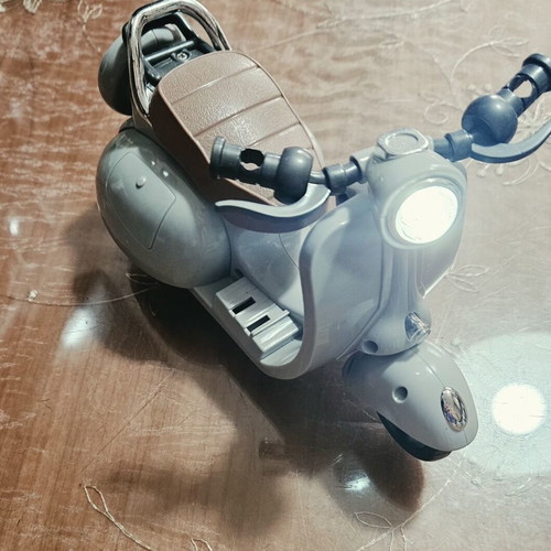 Toy motorcycle for dolls, plays music and moves