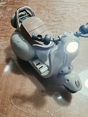 Toy motorcycle for dolls, plays music and moves