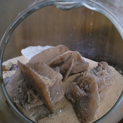 Desert rose used with agate and amethyst in glass bowl