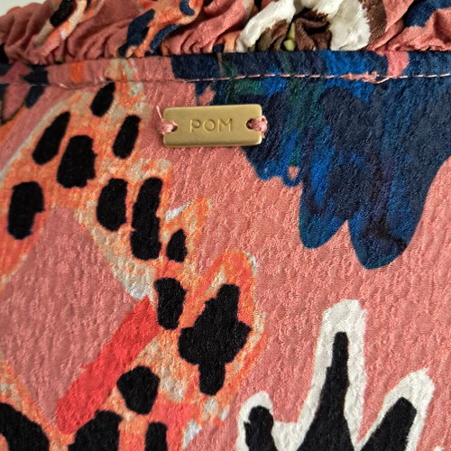 Pom dress used with geometric pattern in pink, blue and green
