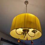 Ceiling light with brass parts and yellow lampshade