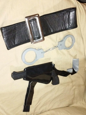 Police set used with belt, holster, plastic gun and handcuffs