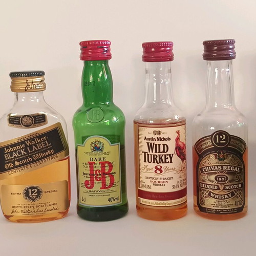 7 mini whiskey bottles, sealed plastic