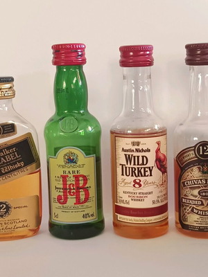 7 mini whiskey bottles, sealed plastic