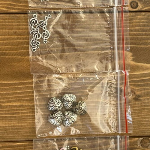 Metal beads and symbols pack like new, 12 bags
