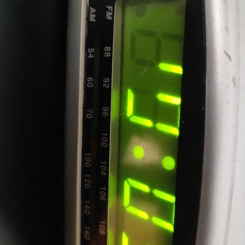 Digital alarm clock used with radio and minor display lines