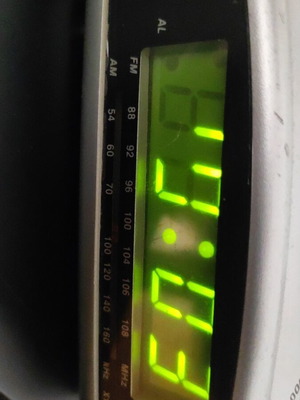 Digital alarm clock used with radio and minor display lines