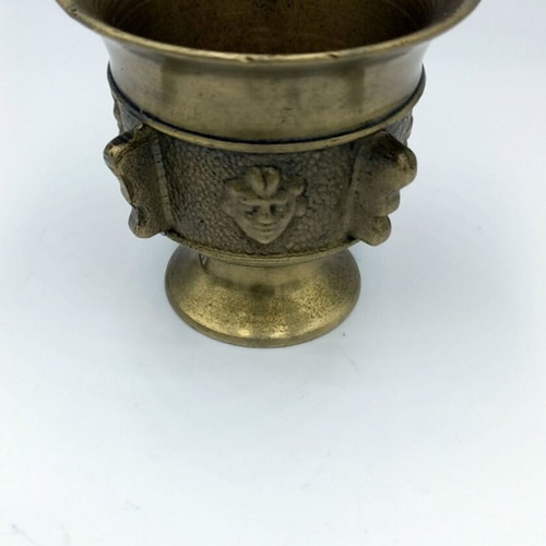 Metal mortar used with face and plant decoration