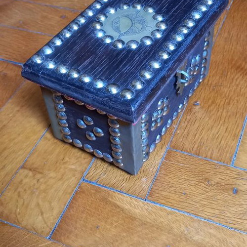 Decorative small wooden chest used with metal details
