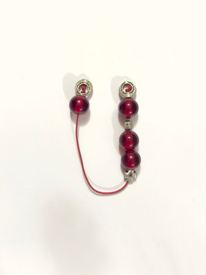 Small worry beads used with red translucent beads and metal details