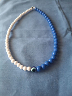 Handmade necklace with blue and white beads and evil eye