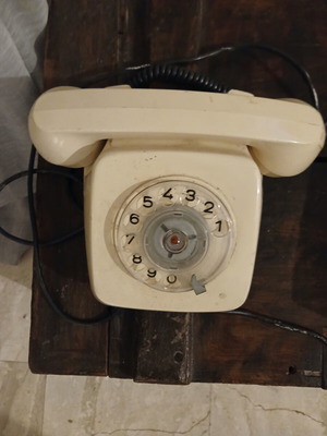 Analog phone used, 1980s white wired