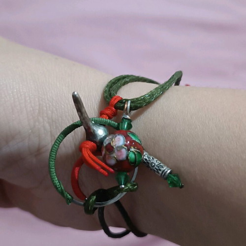 Bracelet new with various charms on green cord