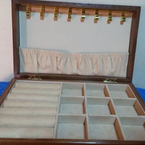 Wooden jewelry box used with velvet-lined compartments