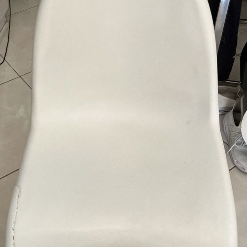 White modern plastic chair with crack