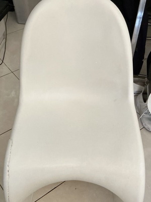 White modern plastic chair with crack