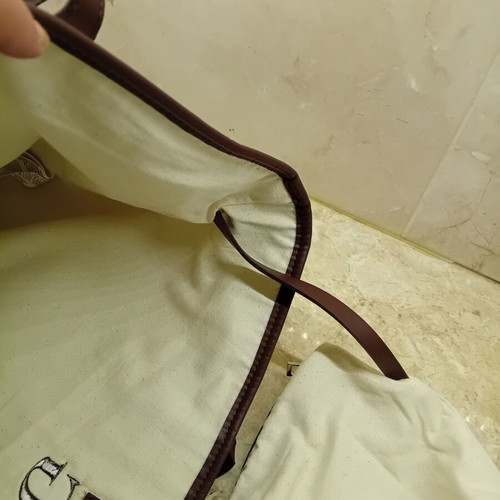 Large beige fabric shoulder bag with brown leather details