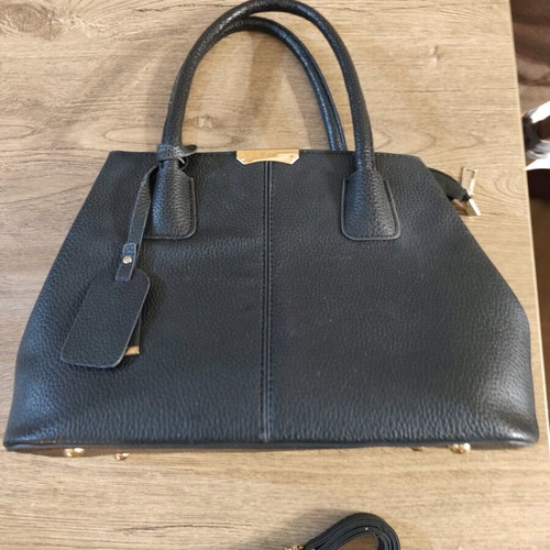 Black handbag used with embossed texture and adjustable strap